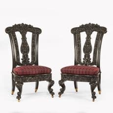 A pair of Anglo-Ceylonese ebony hall chairs